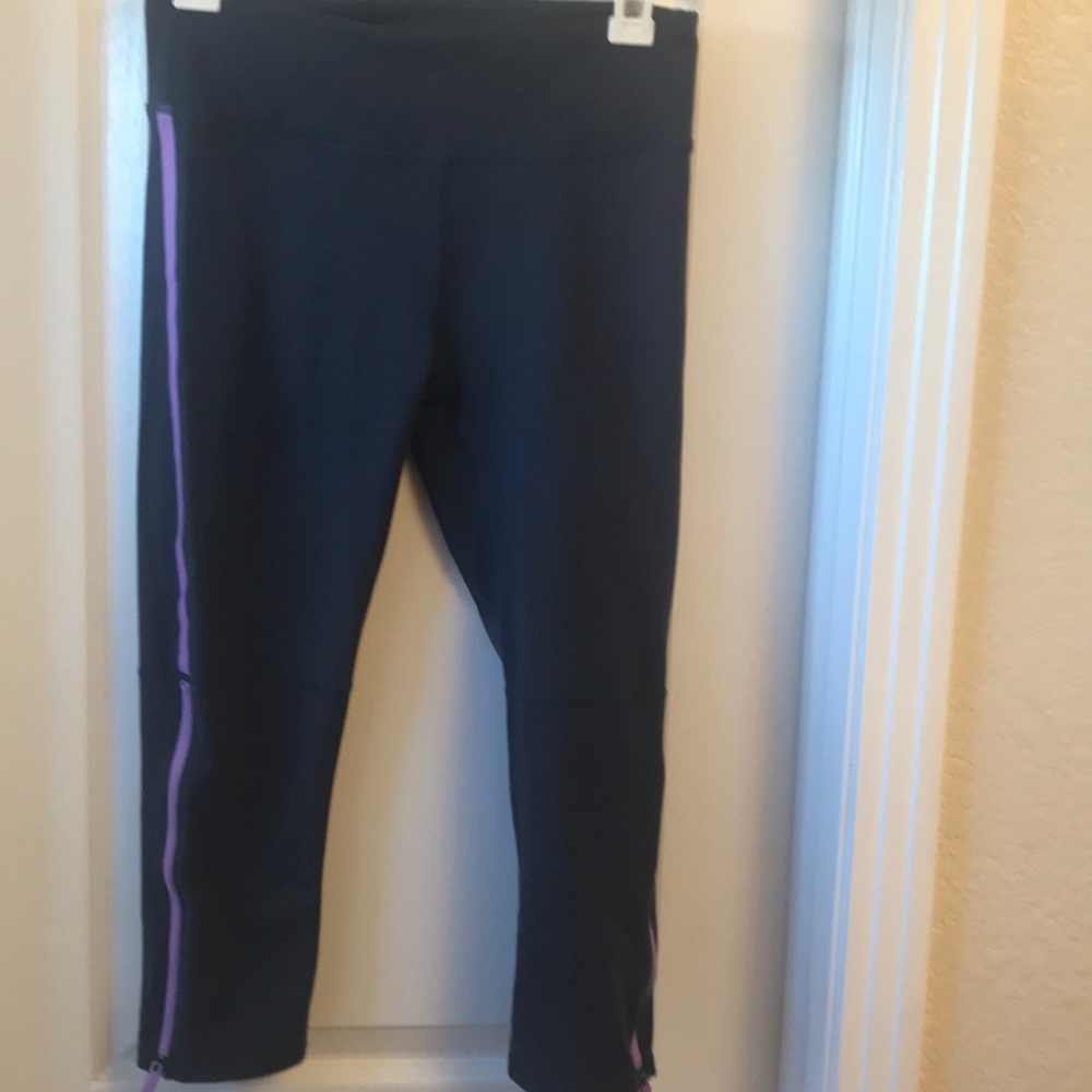 Charcoal gray leggings with ankle zip detail.